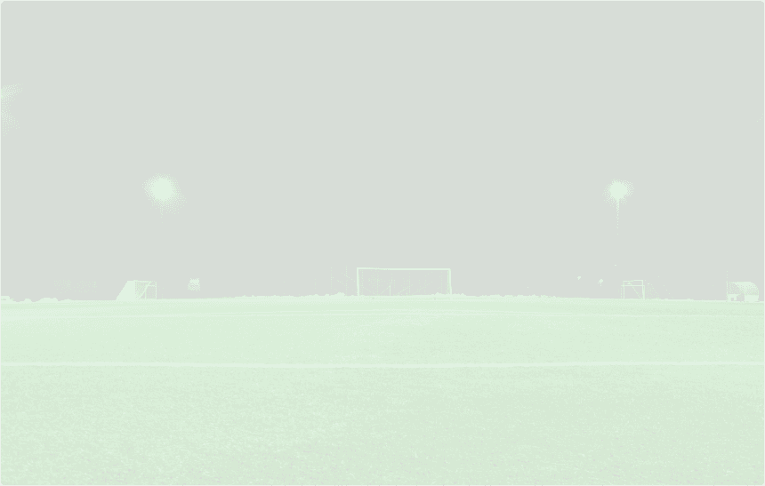 a panaromic view of a football field, with goal post in the center of the view